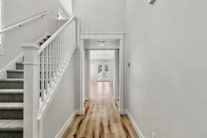 Stairway with wood finished floors and french doors