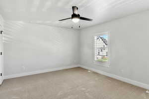 Empty room featuring light carpet and ceiling fan