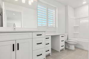 Bathroom with vanity,  shower combination, recessed lighting, and light tile patterned floors