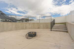 Oversized circular patio, walled and fenced, ready to be filled with furniture, a fire pit, or whatever suits your entertainment style.