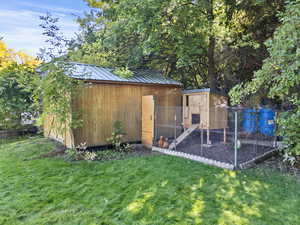 View of poultry coop featuring a yard