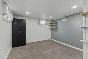 Basement with light colored carpet and recessed lighting