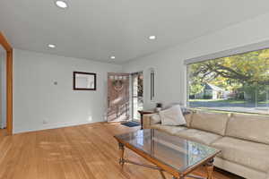 Living room with recessed lighting and light wood finished floors