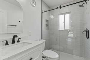 Bathroom featuring a stall shower and vanity
