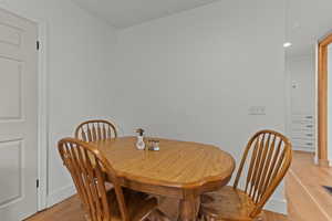 Dining room with light wood-style flooring and baseboards