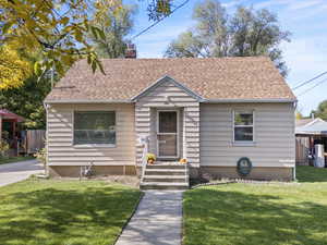 Bungalow with a chimney and roof with shingles