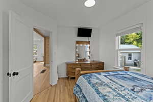Bedroom with light wood finished floors and baseboards