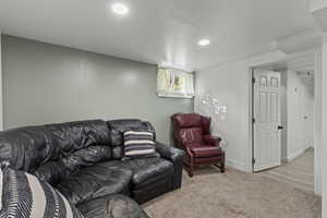Carpeted living room featuring baseboards and recessed lighting