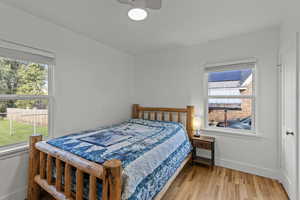 Bedroom with light wood-type flooring and a ceiling fan