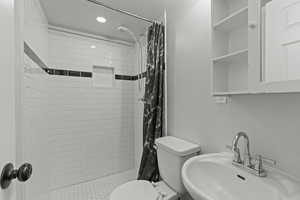 Bathroom featuring a shower stall and recessed lighting