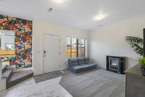 Living room or optional office space featuring tile walkway and carpet