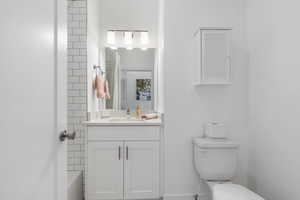 Full Bathroom with vanity and shower / bath combo with custom tile