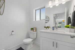 Half bathroom with vanity and penny tile  flooring