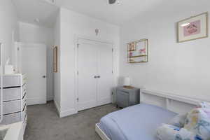 Bedroom with carpet, a closet, and a ceiling fan