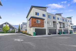 View of property featuring an attached garage and a residential view