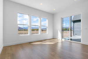 Unfurnished room featuring a mountain view, recessed lighting, and light wood-style flooring