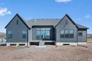 Rear view of property with a shingled roof