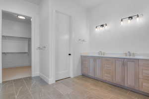 Bathroom with double vanity and a spacious closet