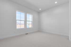 Unfurnished room with light carpet and recessed lighting