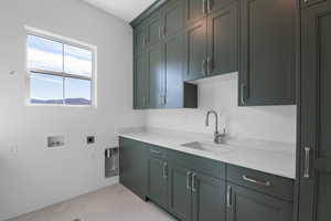Laundry area featuring light tile patterned floors, hookup for an electric dryer, hookup for a washing machine, and cabinet space