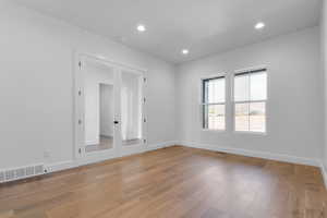 Unfurnished room featuring recessed lighting, light wood-type flooring, and french doors