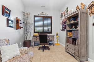 Office with light tile patterned floors and baseboards