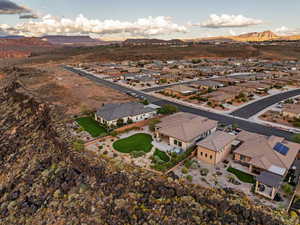 Aerial view of property and surrounding area with a mountainous background and nearby suburban area