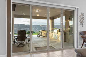 Doorway featuring a mountain view and tile patterned flooring