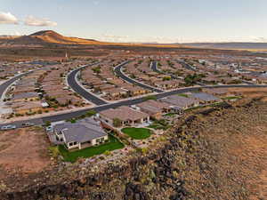 Aerial view of property and surrounding area featuring nearby suburban area and mountains