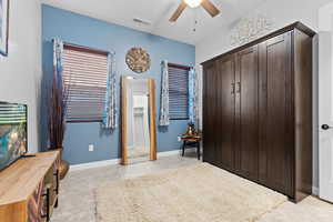Bedroom featuring a ceiling fan, a closet, and light tile patterned floors