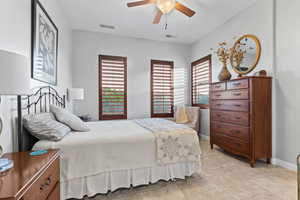 Bedroom with multiple windows, ceiling fan, and light tile patterned flooring