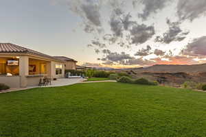 Yard at dusk featuring a patio