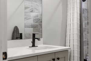 Full bath with vanity and curtained shower