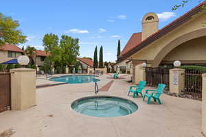 Community pool featuring a community hot tub and a patio