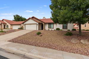 Mediterranean / spanish house featuring a tile roof, stucco siding, concrete driveway, and an attached garage