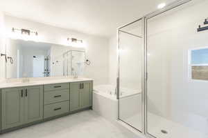Bathroom featuring a shower stall, a bath, double vanity, and light marble finish floors