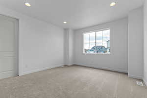 Unfurnished room featuring light colored carpet and recessed lighting