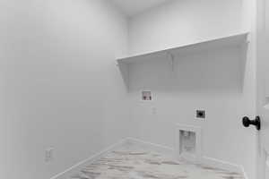 Washroom featuring hookup for an electric dryer, light marble finish flooring, and hookup for a washing machine