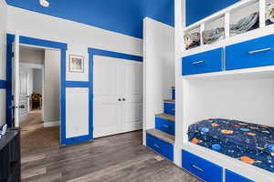 Bedroom with a closet and dark wood finished floors