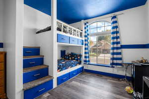 Bedroom with dark wood-style flooring