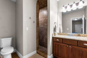 Full bath featuring a shower stall, vanity, and light tile patterned flooring