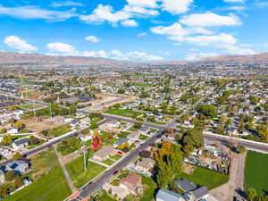 Aerial overview of property's location with mountains and nearby suburban area