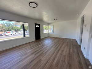 Entrance foyer featuring a textured ceiling and dark wood-style flooring