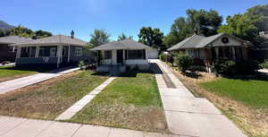 Bungalow-style home with a front yard
