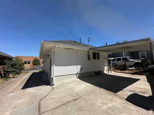 Rear view of house featuring driveway