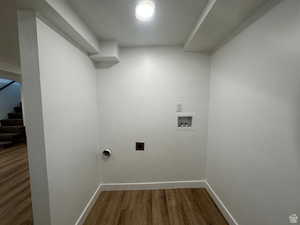 Laundry room with wood finished floors, hookup for an electric dryer, and washer hookup