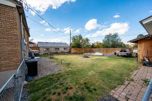 Fenced backyard with a patio area and an outdoor fire pit