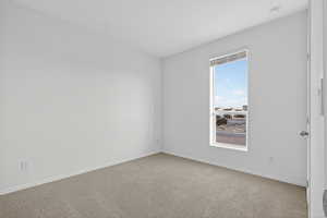 Empty room with carpet floors and baseboards
