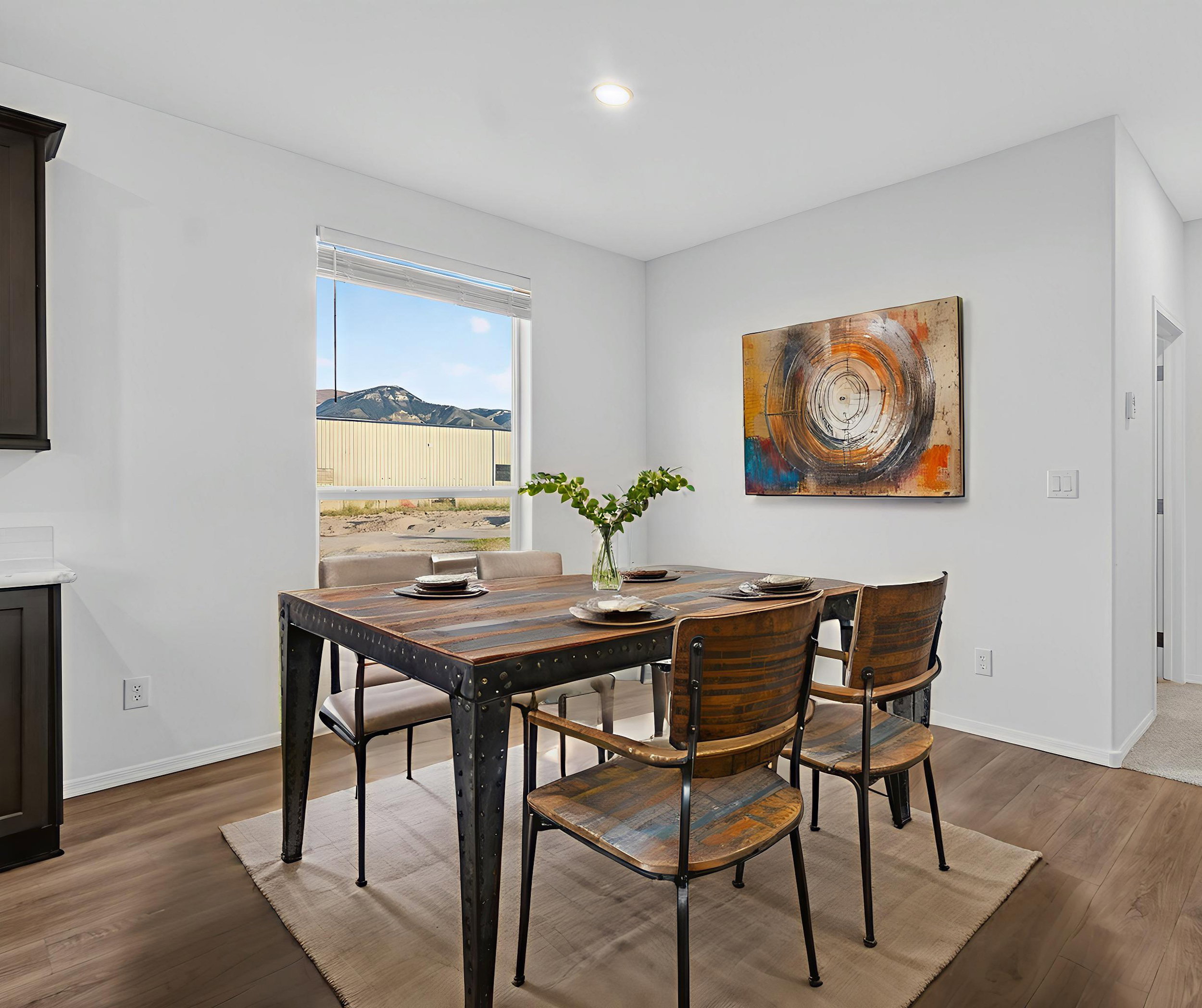 *Virtually staged* Dining area with wood finished floors and recessed lighting