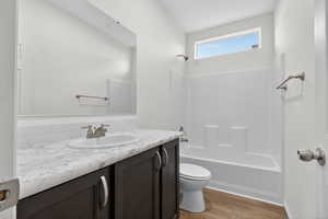 Full bath with vanity, bathtub / shower combination, and light wood-style floors
